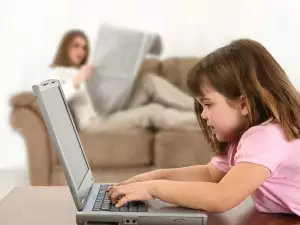 A girl playing on the laptop